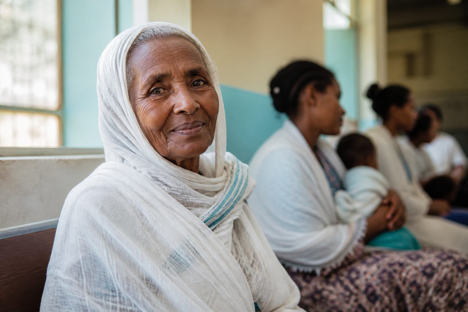 An elderly Ethiopian mother waiting to be seen at a community health clinic